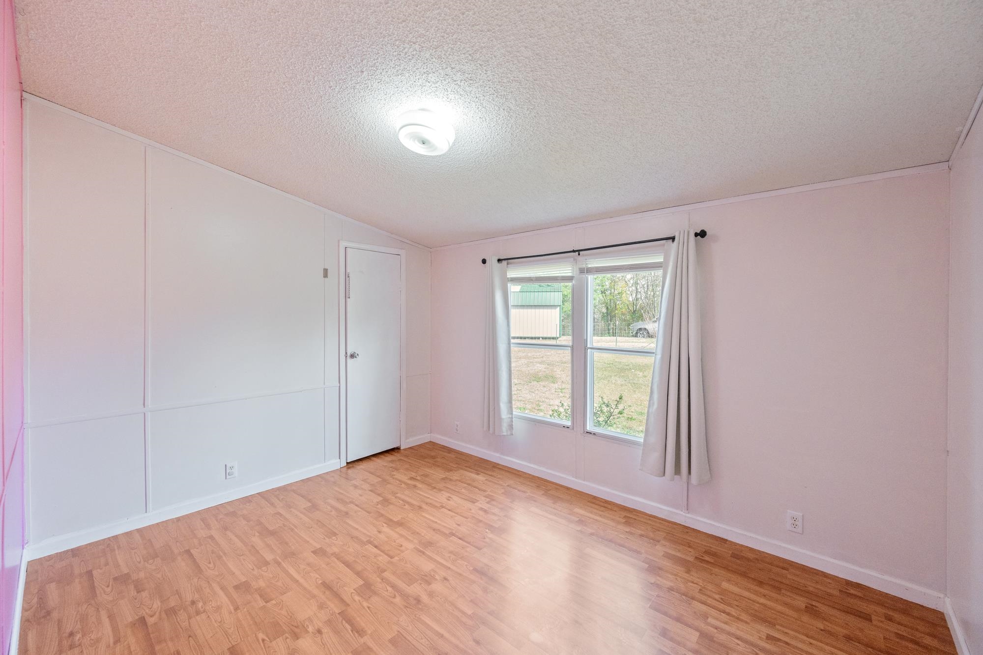 875 Lindsey Road Parsons, TN 38363 - Photo 15 of 38 a view of empty room with wooden floor and fan