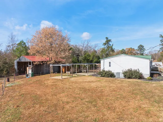 a backyard of a house with table and chairs