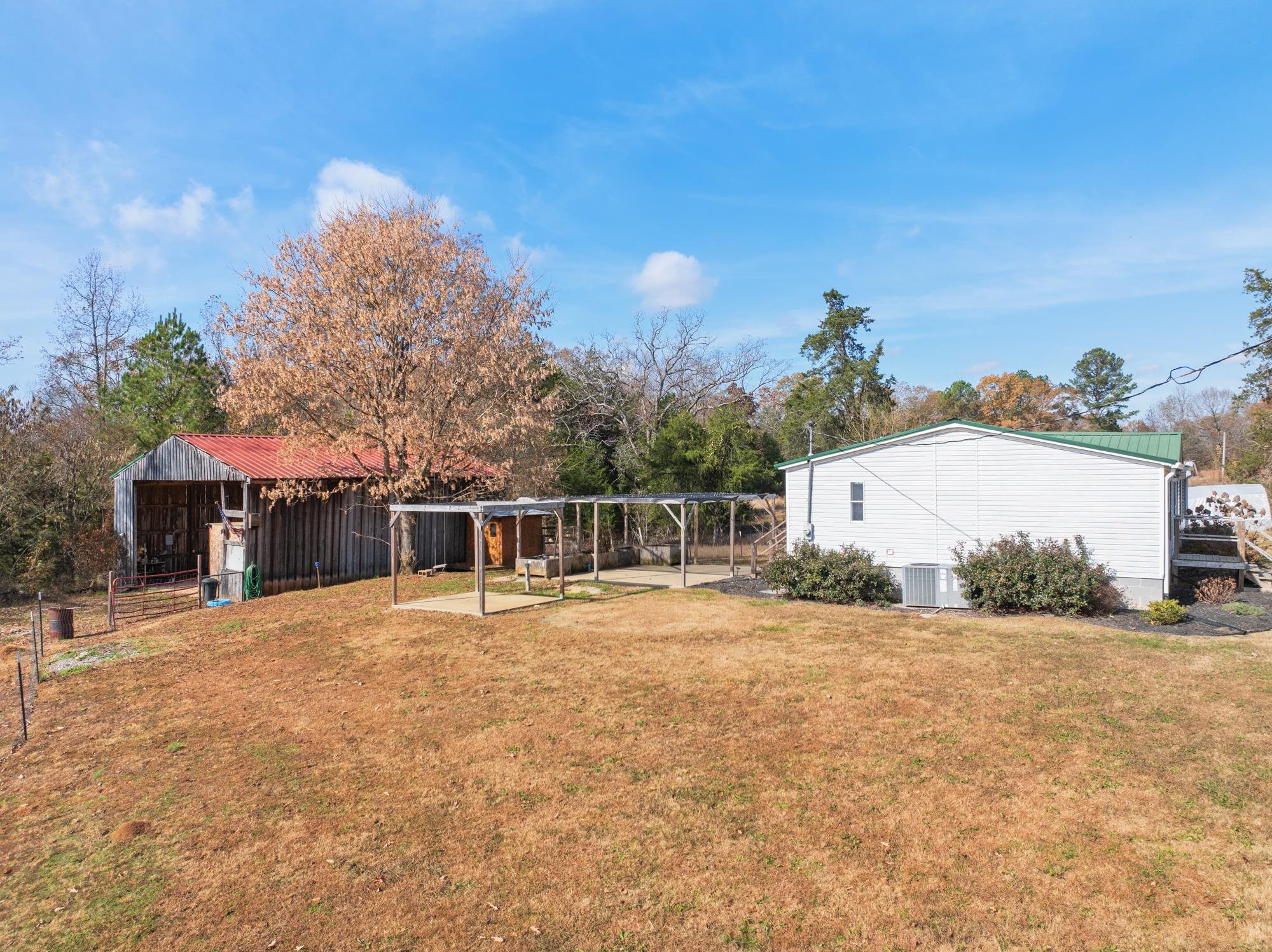 875 Lindsey Road Parsons, TN 38363 - Photo 23 of 38 a backyard of a house with table and chairs