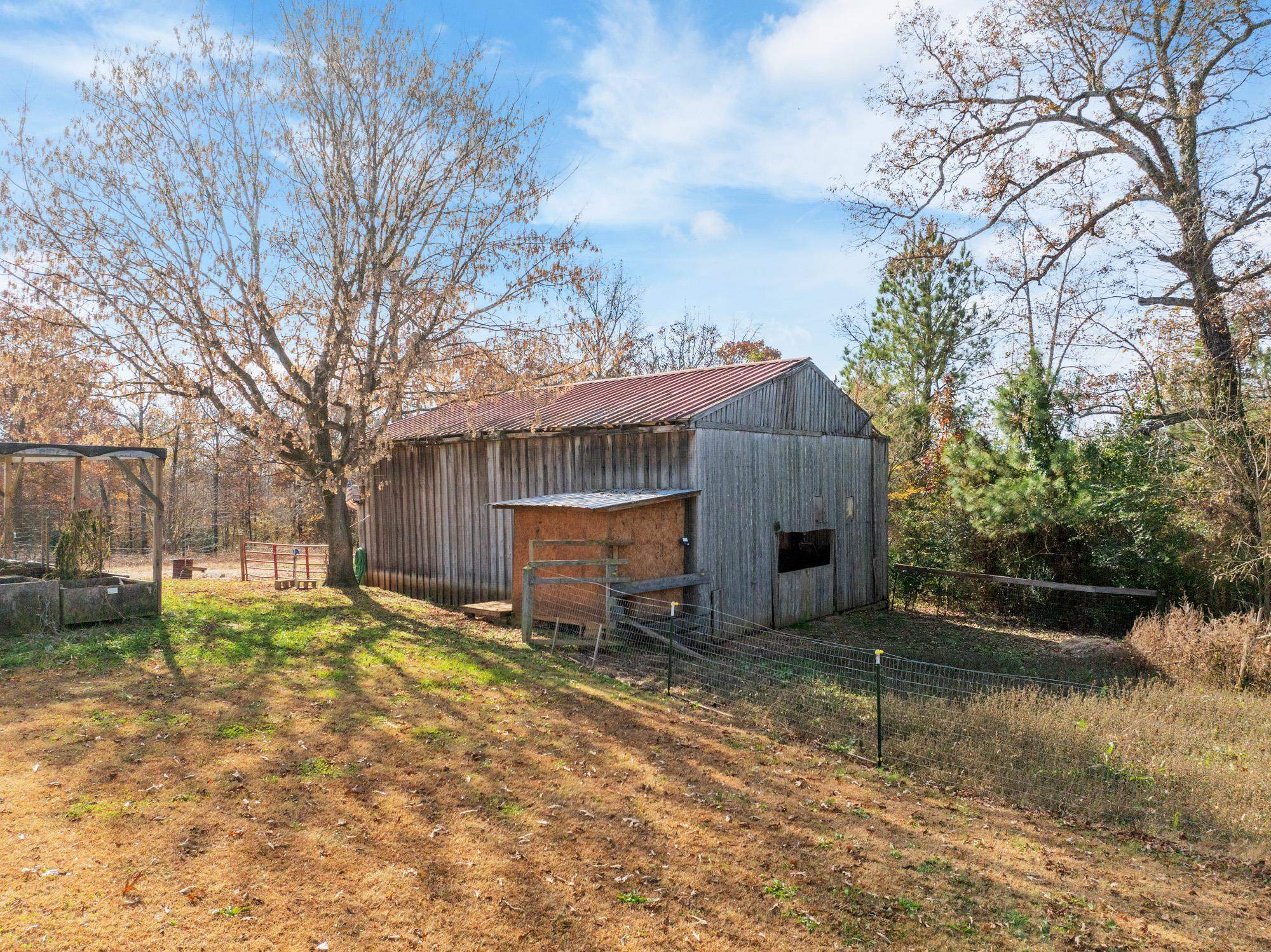 875 Lindsey Road Parsons, TN 38363 - Photo 26 of 38 a view of a house with a yard covered with snow