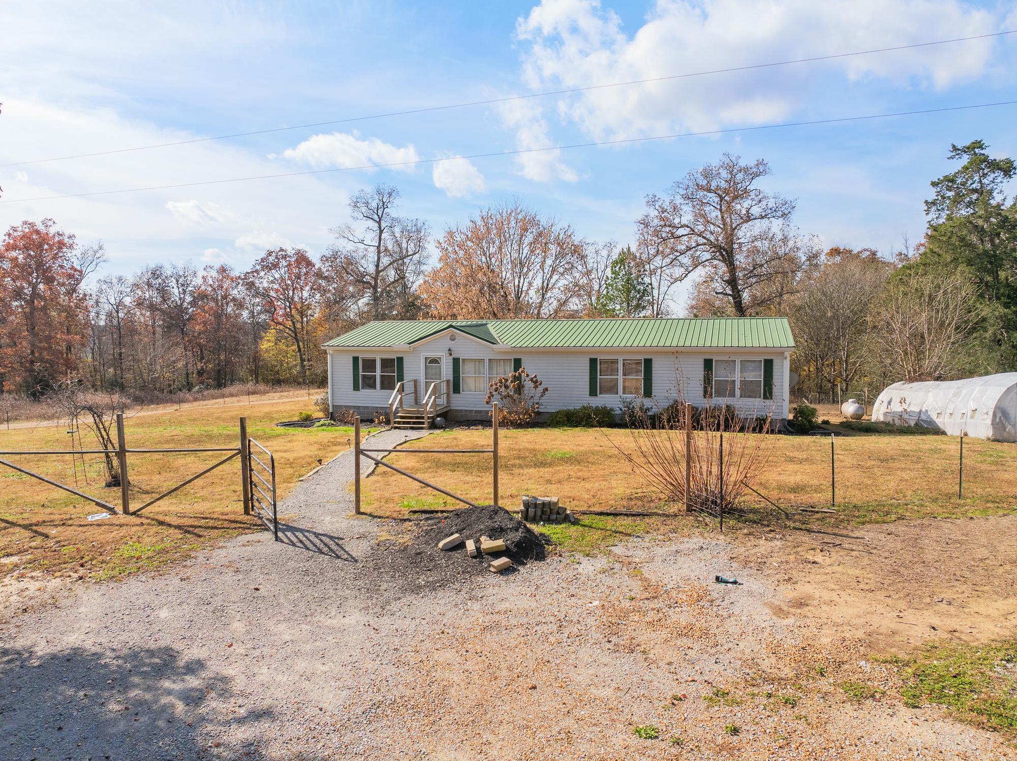 875 Lindsey Road Parsons, TN 38363 - Photo 34 of 38 a view of house with backyard and swimming pool
