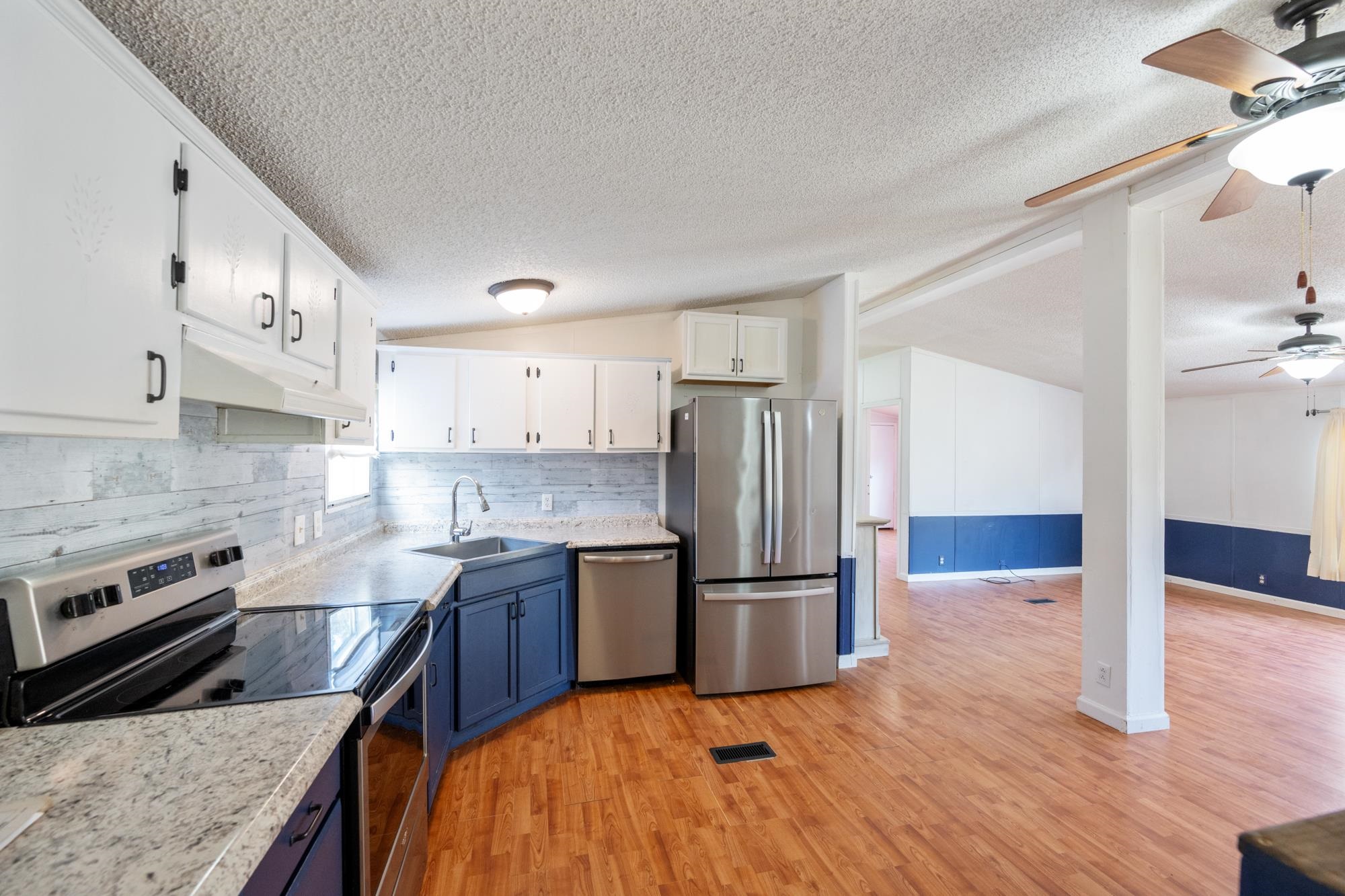 875 Lindsey Road Parsons, TN 38363 - Photo 5 of 38 a kitchen with stainless steel appliances granite countertop a refrigerator a stove and a sink