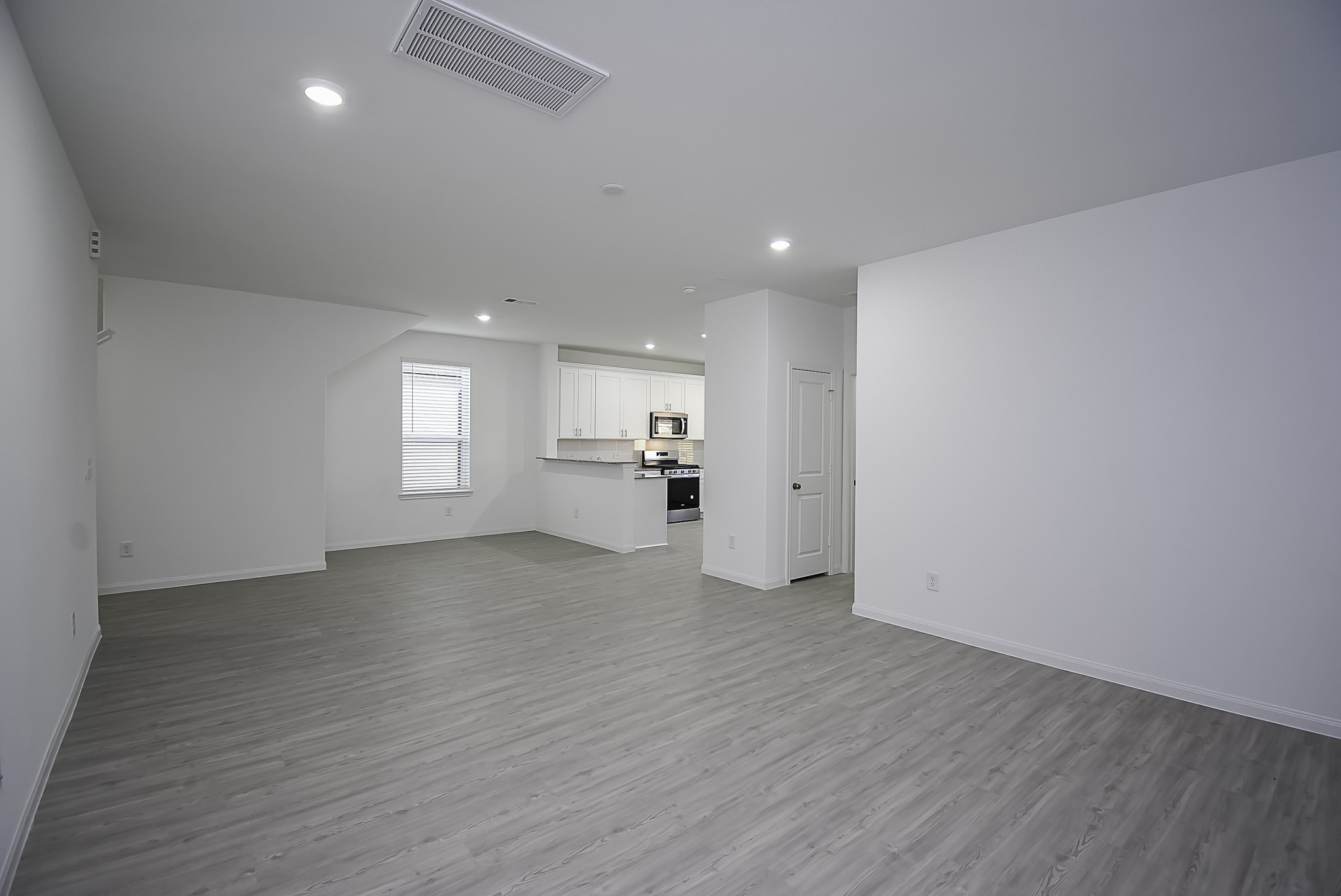 23407 Honey Spade Road Hockley, TX 77447 - Photo 15 of 34 an empty room with wooden floor and windows