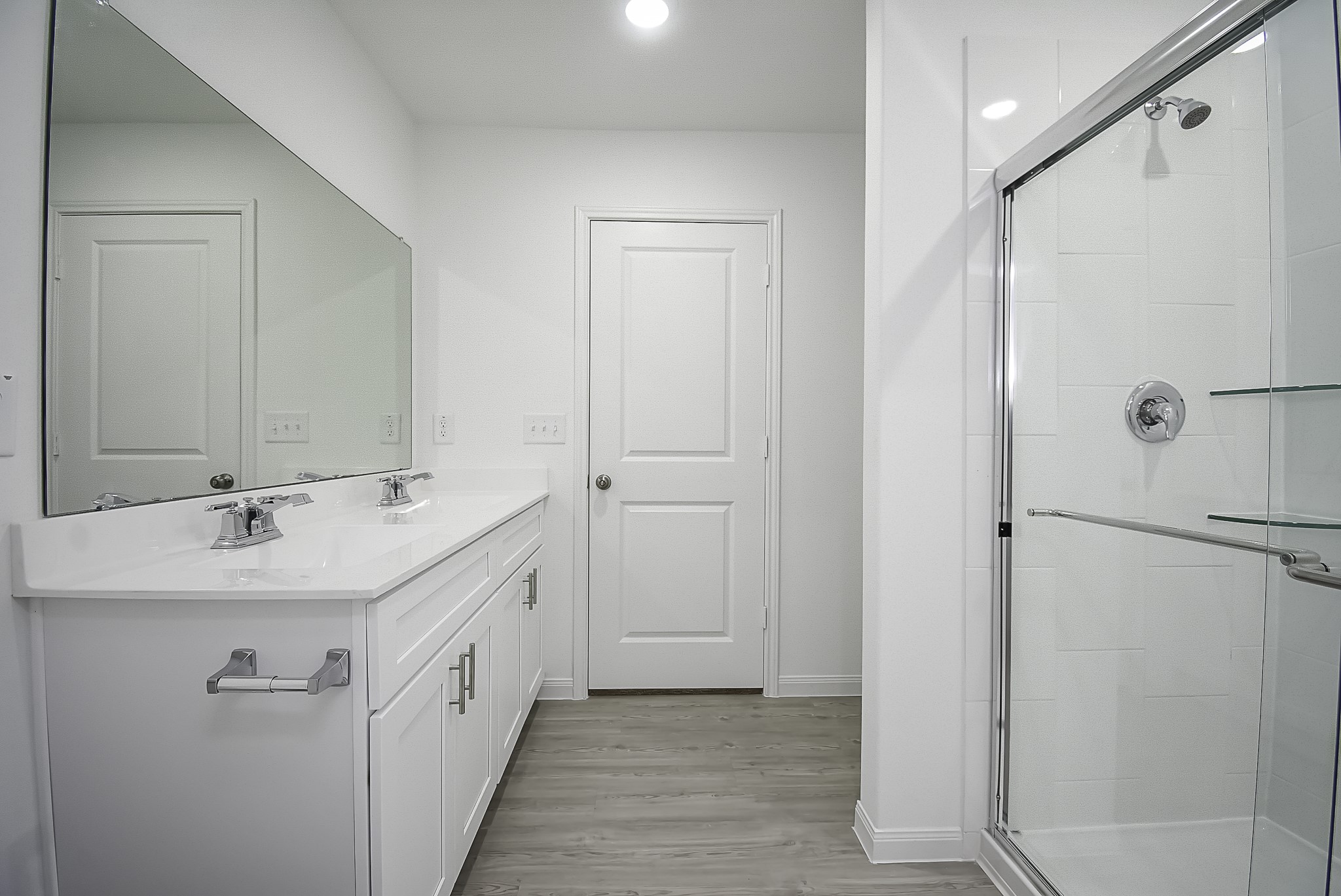 23407 Honey Spade Road Hockley, TX 77447 - Photo 18 of 34 a bathroom with a double vanity sink a mirror and a shower