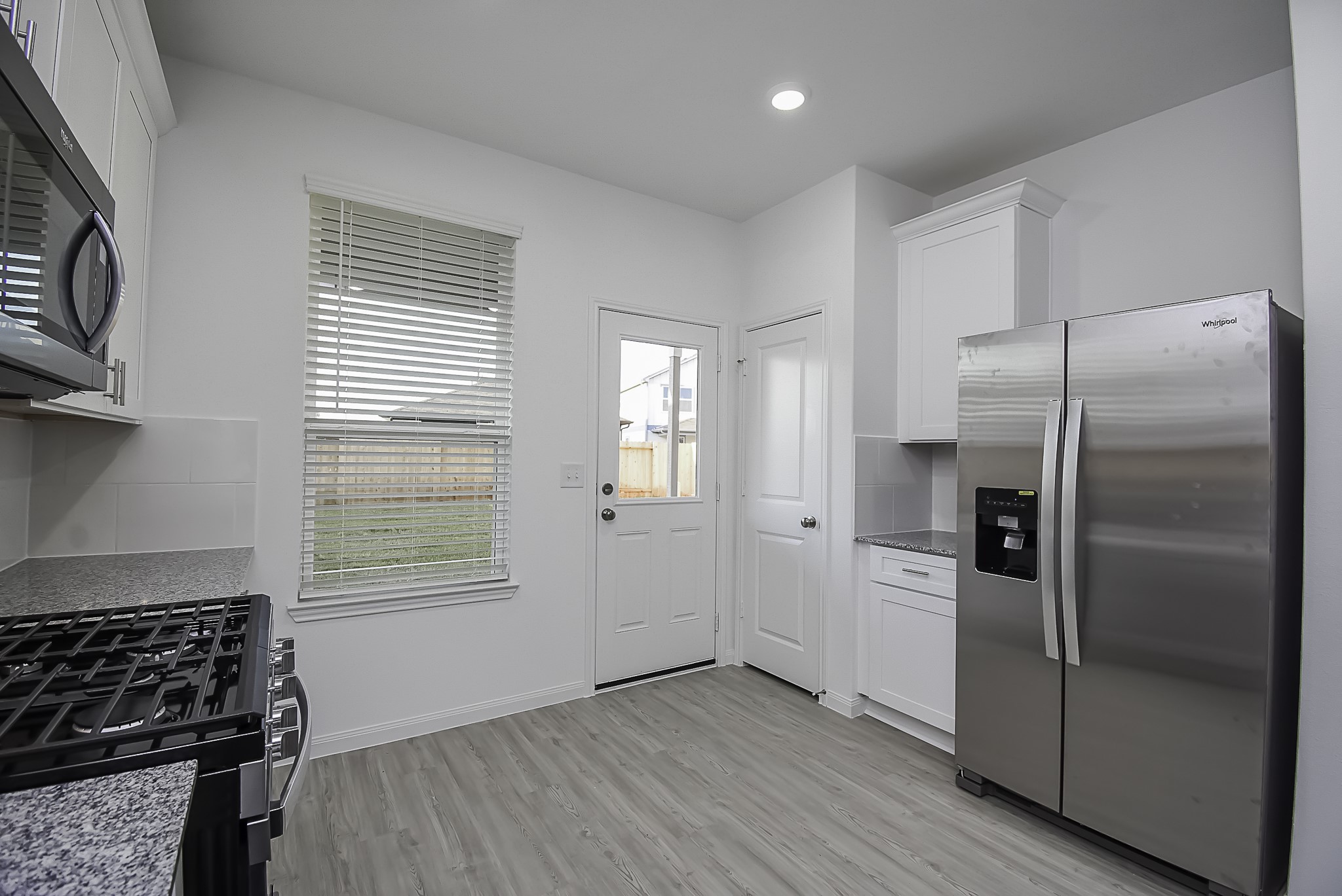 23407 Honey Spade Road Hockley, TX 77447 - Photo 2 of 34 a kitchen with stainless steel appliances granite countertop a refrigerator and a stove top oven