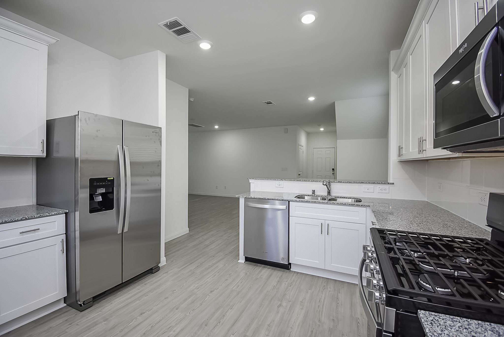 23407 Honey Spade Road Hockley, TX 77447 - Photo 4 of 34 a kitchen with a sink stove and refrigerator