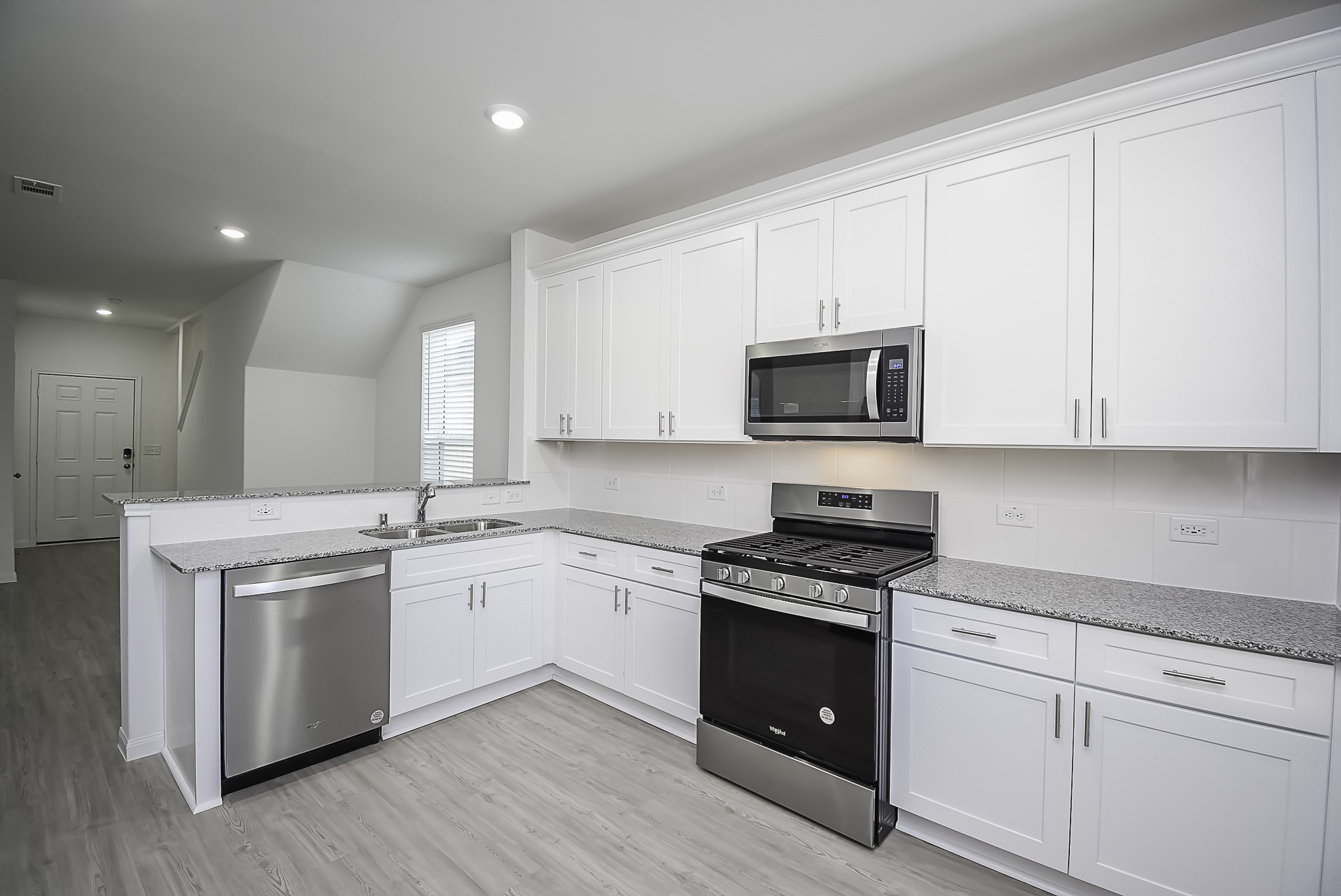 23407 Honey Spade Road Hockley, TX 77447 - Photo 5 of 34 a kitchen with granite countertop white cabinets and stainless steel appliances