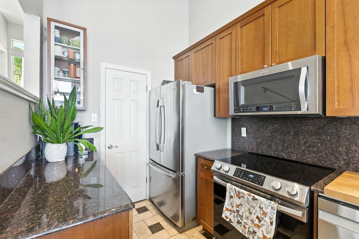 2918 Ranch Road 620, Unit 185 Austin, TX 78734 - Photo 12 of 39 a kitchen with a stove a microwave and cabinets