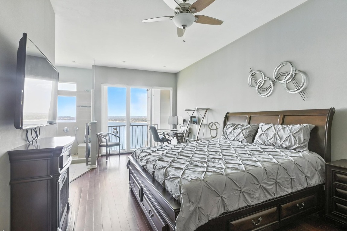 2918 Ranch Road 620, Unit 185 Austin, TX 78734 - Photo 14 of 39 a bedroom with a large bed and a chandelier