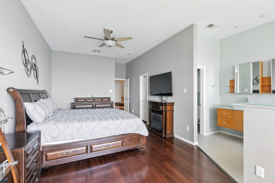 2918 Ranch Road 620, Unit 185 Austin, TX 78734 - Photo 15 of 39 a bedroom with a bed and a flat screen tv