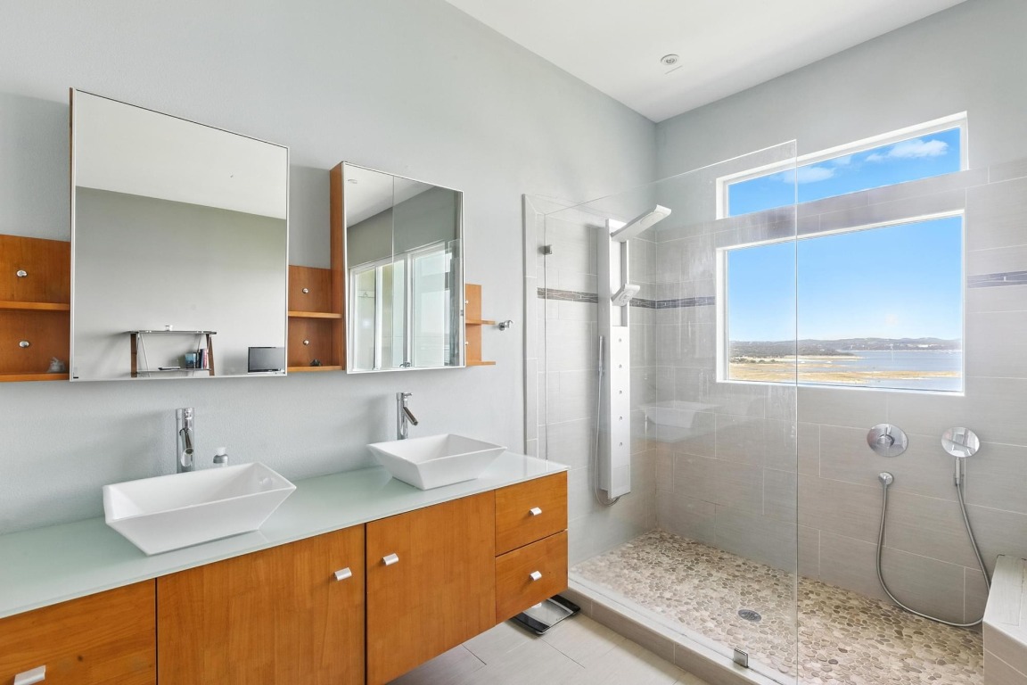 2918 Ranch Road 620, Unit 185 Austin, TX 78734 - Photo 17 of 39 a bathroom with a sink and a mirror