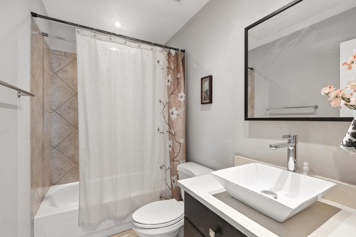 2918 Ranch Road 620, Unit 185 Austin, TX 78734 - Photo 23 of 39 a bathroom with a sink a toilet and shower