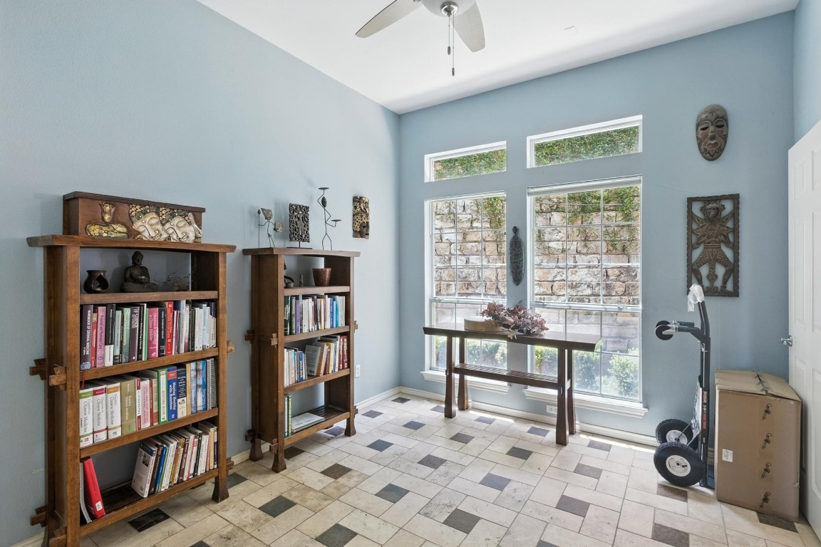 2918 Ranch Road 620, Unit 185 Austin, TX 78734 - Photo 7 of 39 a view of a workspace with bookshelf and a window