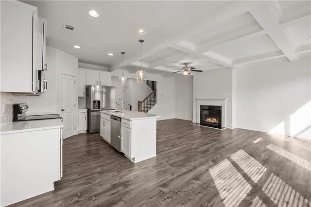 a kitchen with sink cabinets and stainless steel appliances