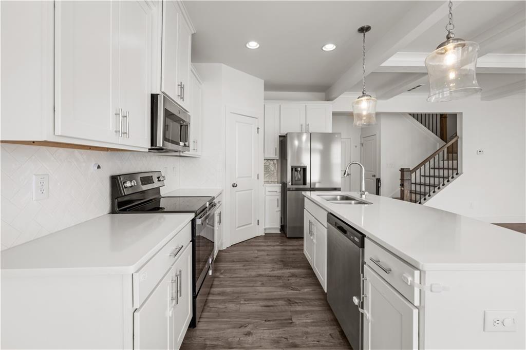 7690 Baron Road Fairburn, GA 30213 - Photo 14 of 29 a kitchen with cabinets and stainless steel appliances