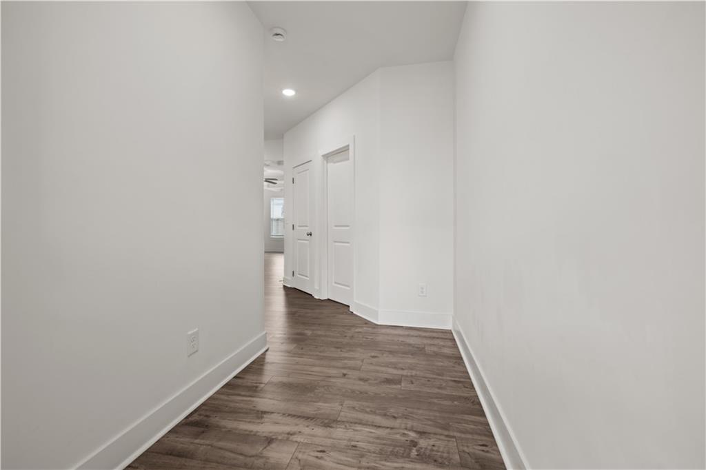 7690 Baron Road Fairburn, GA 30213 - Photo 2 of 29 a view of a hallway with wooden floor