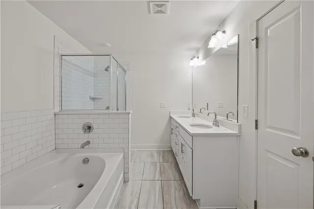 a bathroom with a bathtub a sink a vanity and a mirror