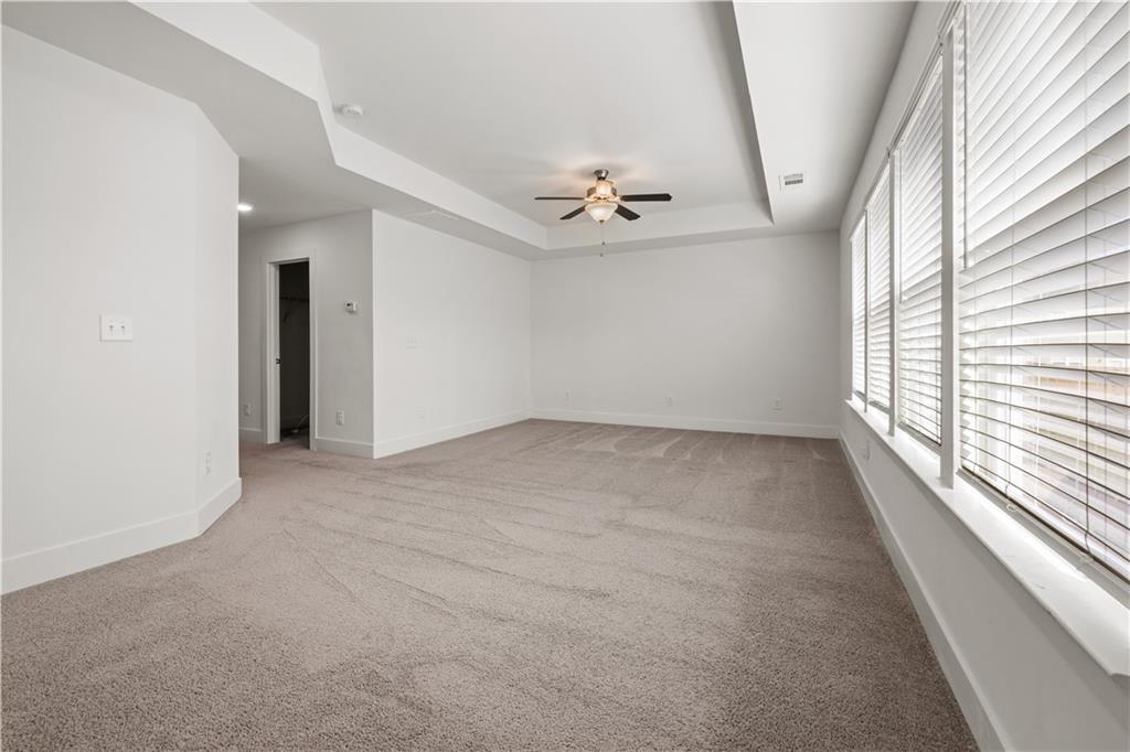 7690 Baron Road Fairburn, GA 30213 - Photo 27 of 29 an empty room with windows and fan