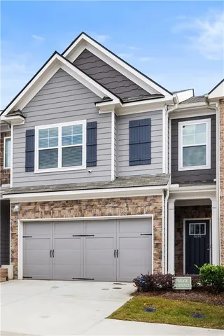 a view of a house with a yard and garage