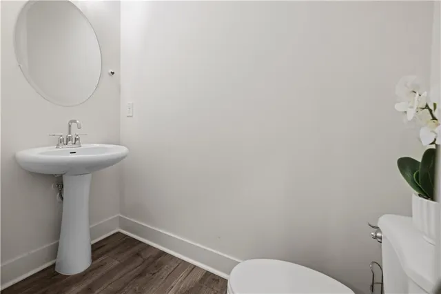 a bathroom with a sink toilet and a mirror