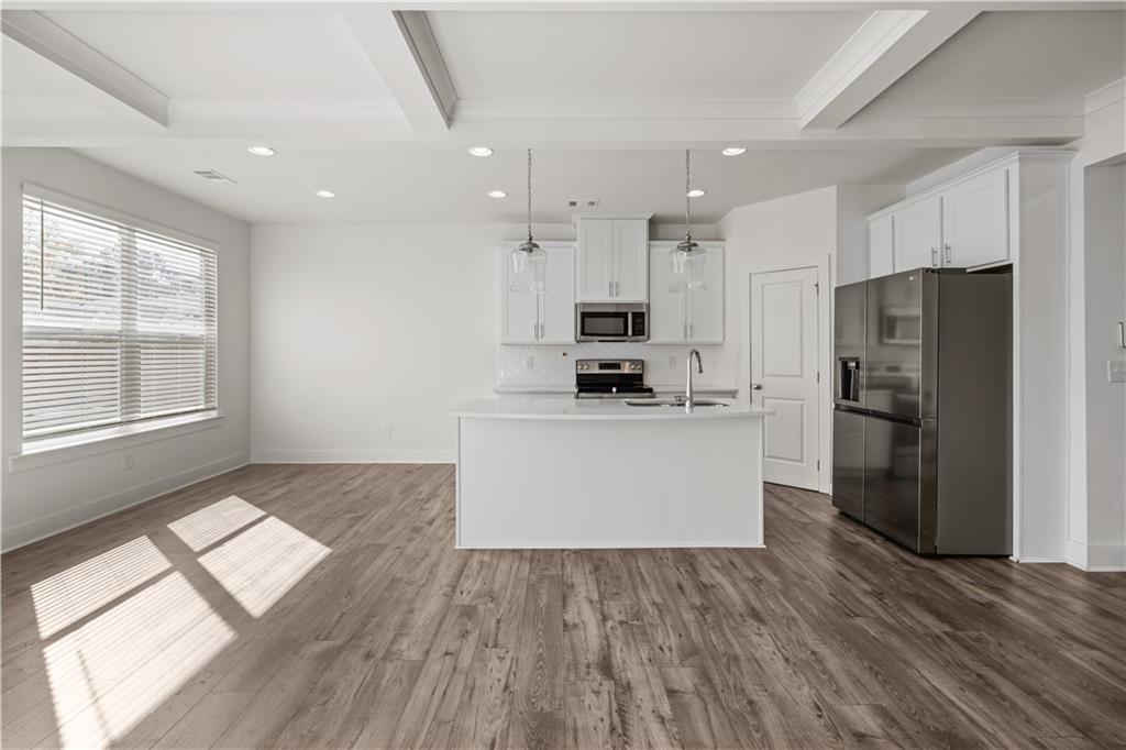 7690 Baron Road Fairburn, GA 30213 - Photo 6 of 29 a kitchen with stainless steel appliances a refrigerator and a stove top oven