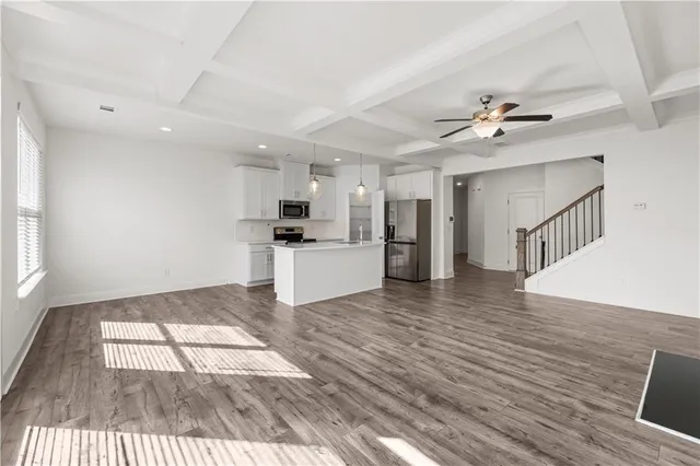a view of kitchen with sink microwave and refrigerator