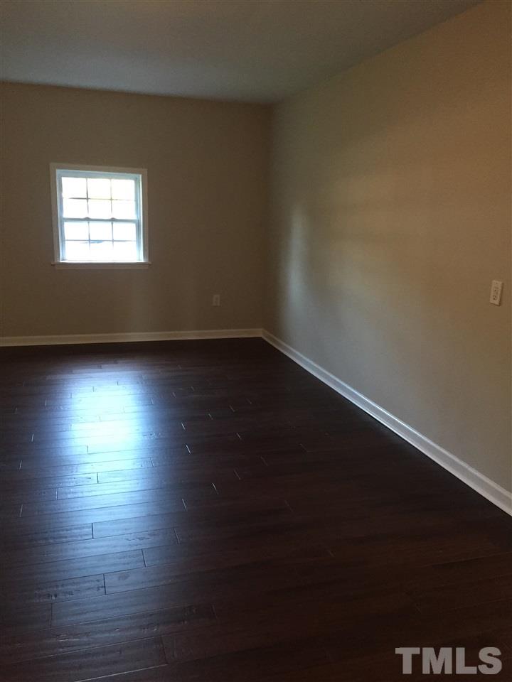 3800 Tryon Ridge Drive Raleigh, NC 27610 - Photo 5 of 18 an empty room with wooden floor and windows