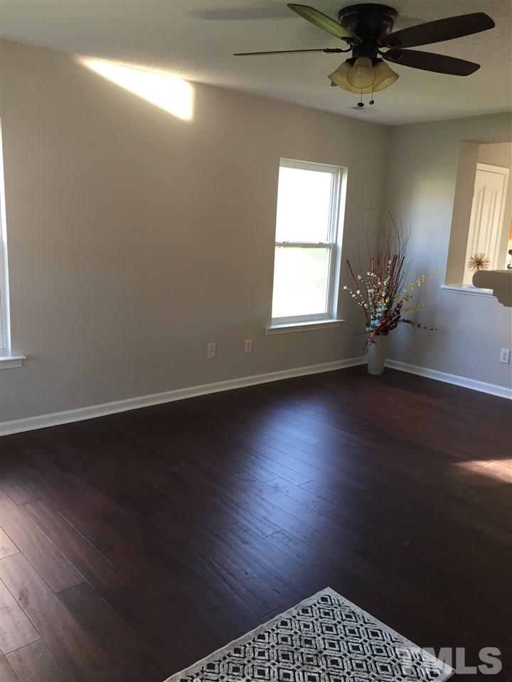 3800 Tryon Ridge Drive Raleigh, NC 27610 - Photo 6 of 18 an empty room with wooden floor and windows