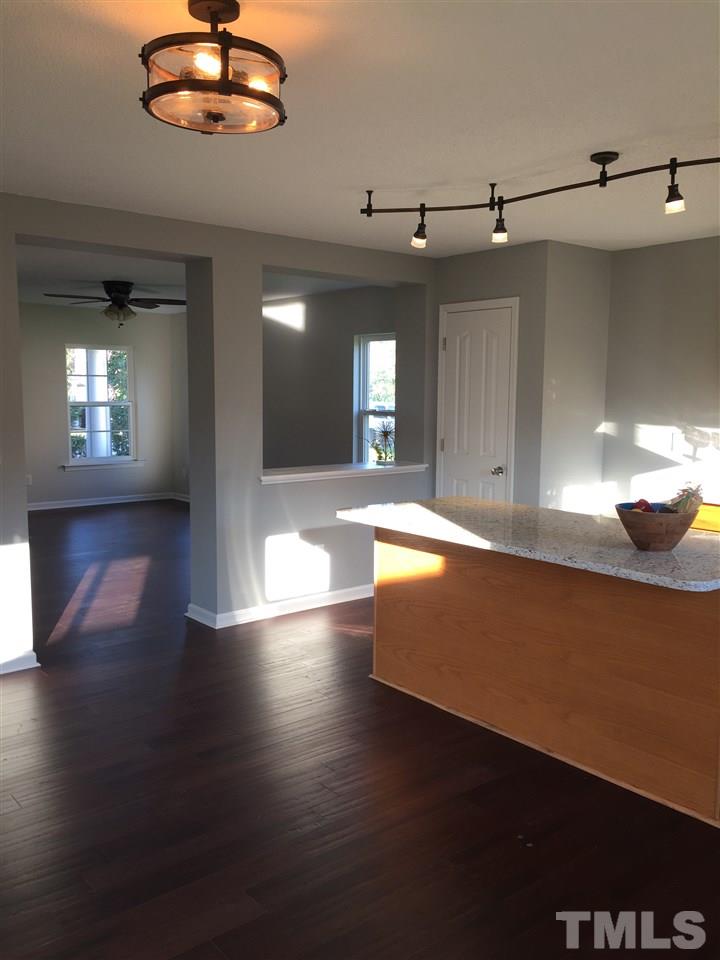 3800 Tryon Ridge Drive Raleigh, NC 27610 - Photo 7 of 18 an open kitchen with chandelier and wooden floor