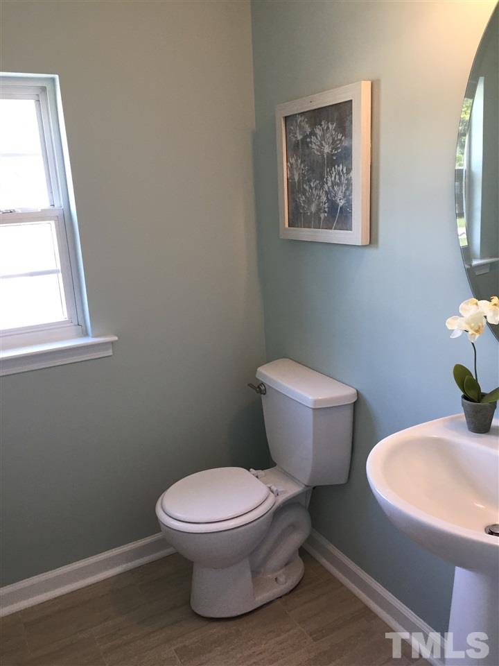 3800 Tryon Ridge Drive Raleigh, NC 27610 - Photo 10 of 18 a white toilet sitting next to a bathroom sink
