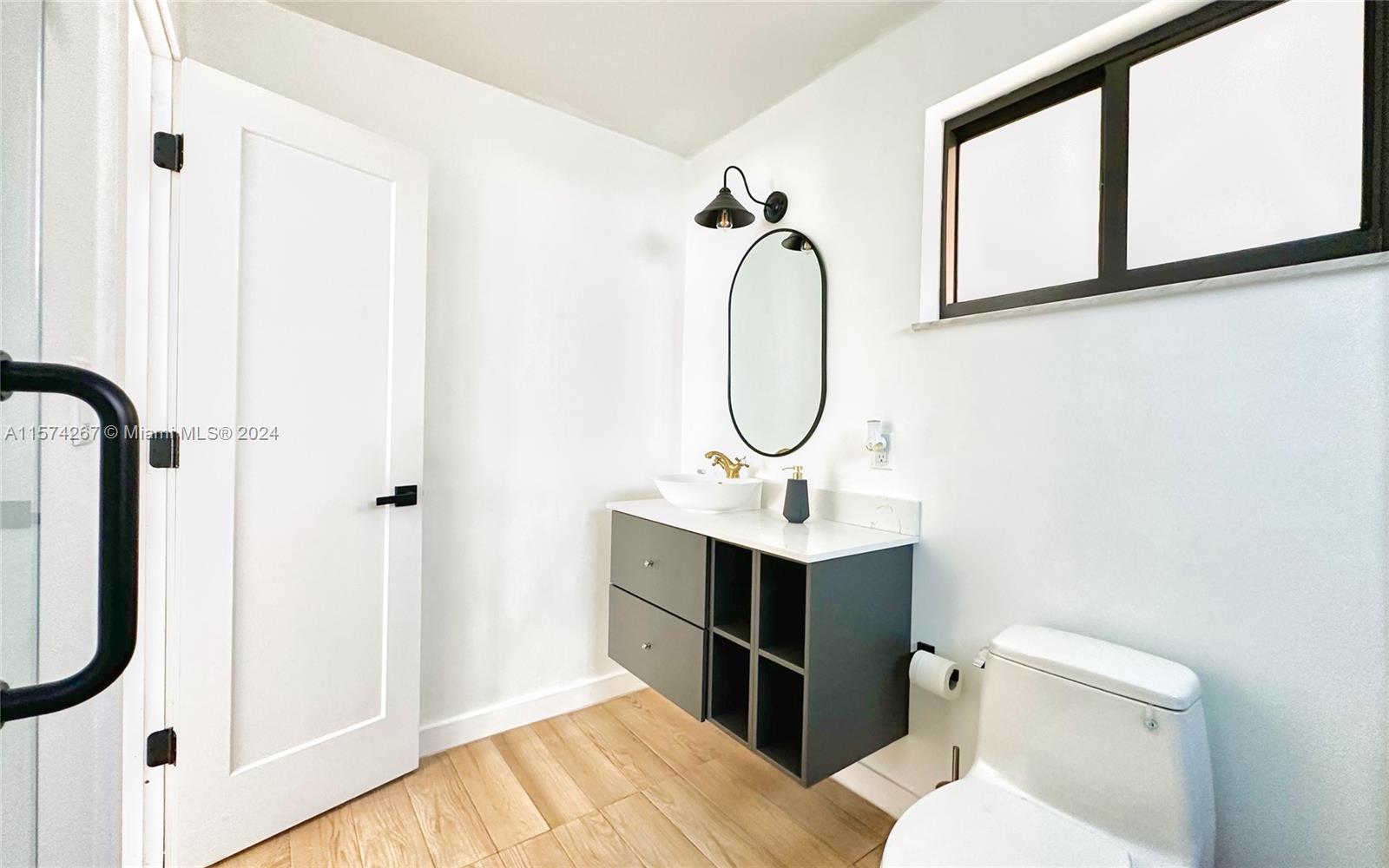7040 Southwest 17th Terrace Miami, FL 33155 - Photo 12 of 26 a bathroom with a sink a toilet and shower