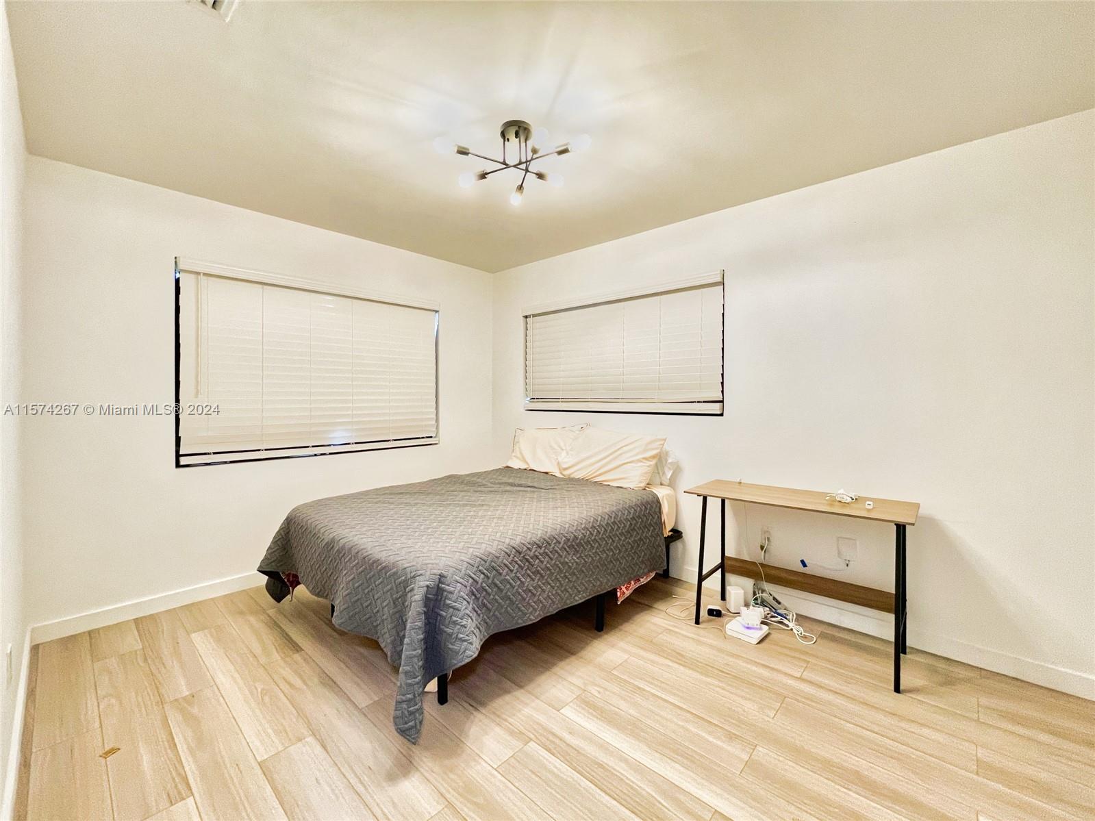 7040 Southwest 17th Terrace Miami, FL 33155 - Photo 14 of 26 a bedroom with a bed and a dresser
