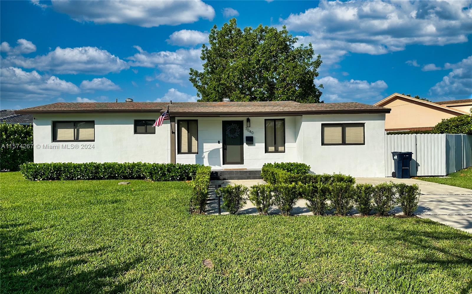 7040 Southwest 17th Terrace Miami, FL 33155 - Photo 2 of 26 a front view of a house with a yard