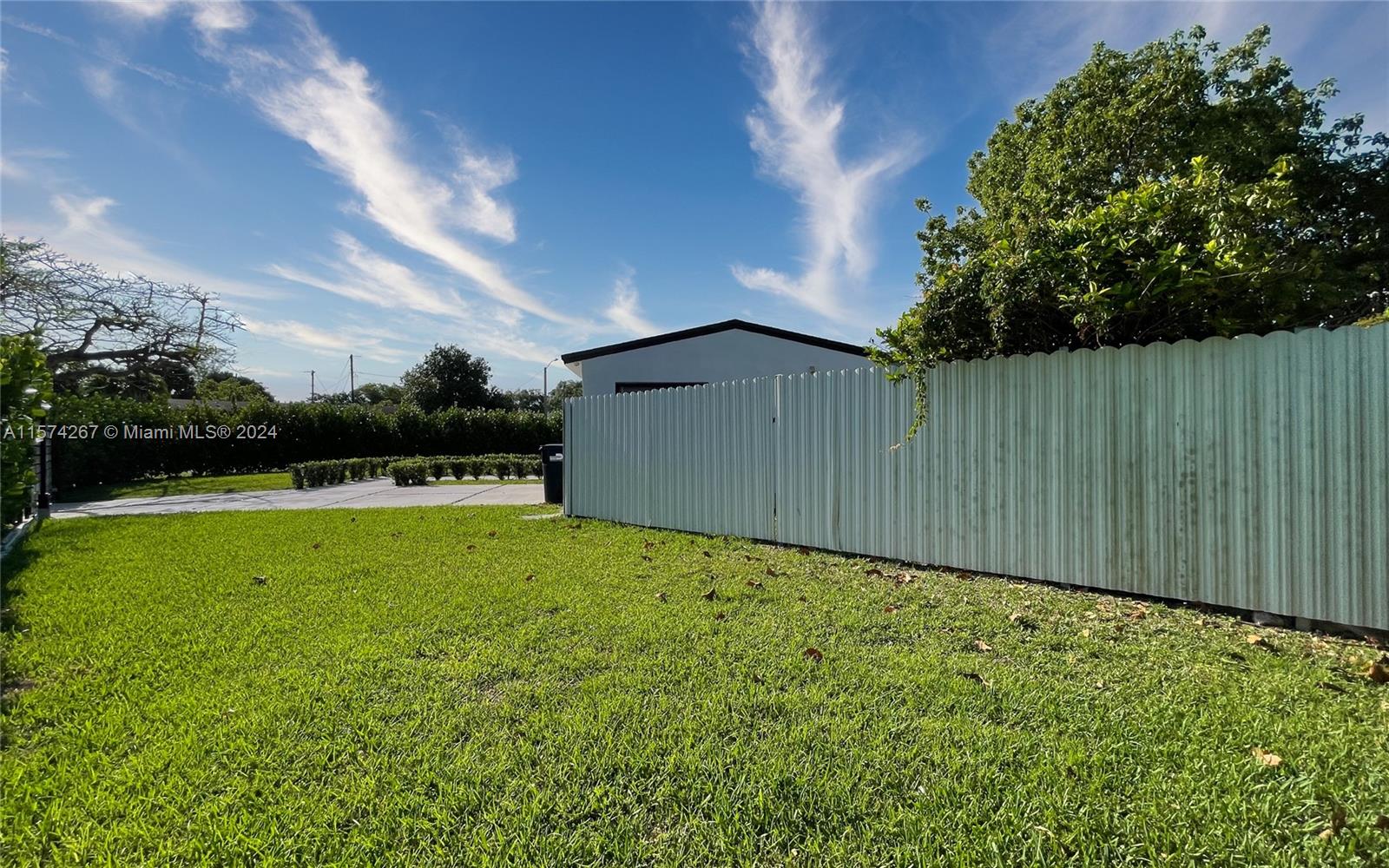 7040 Southwest 17th Terrace Miami, FL 33155 - Photo 24 of 26 a backyard of a house with lots of green space