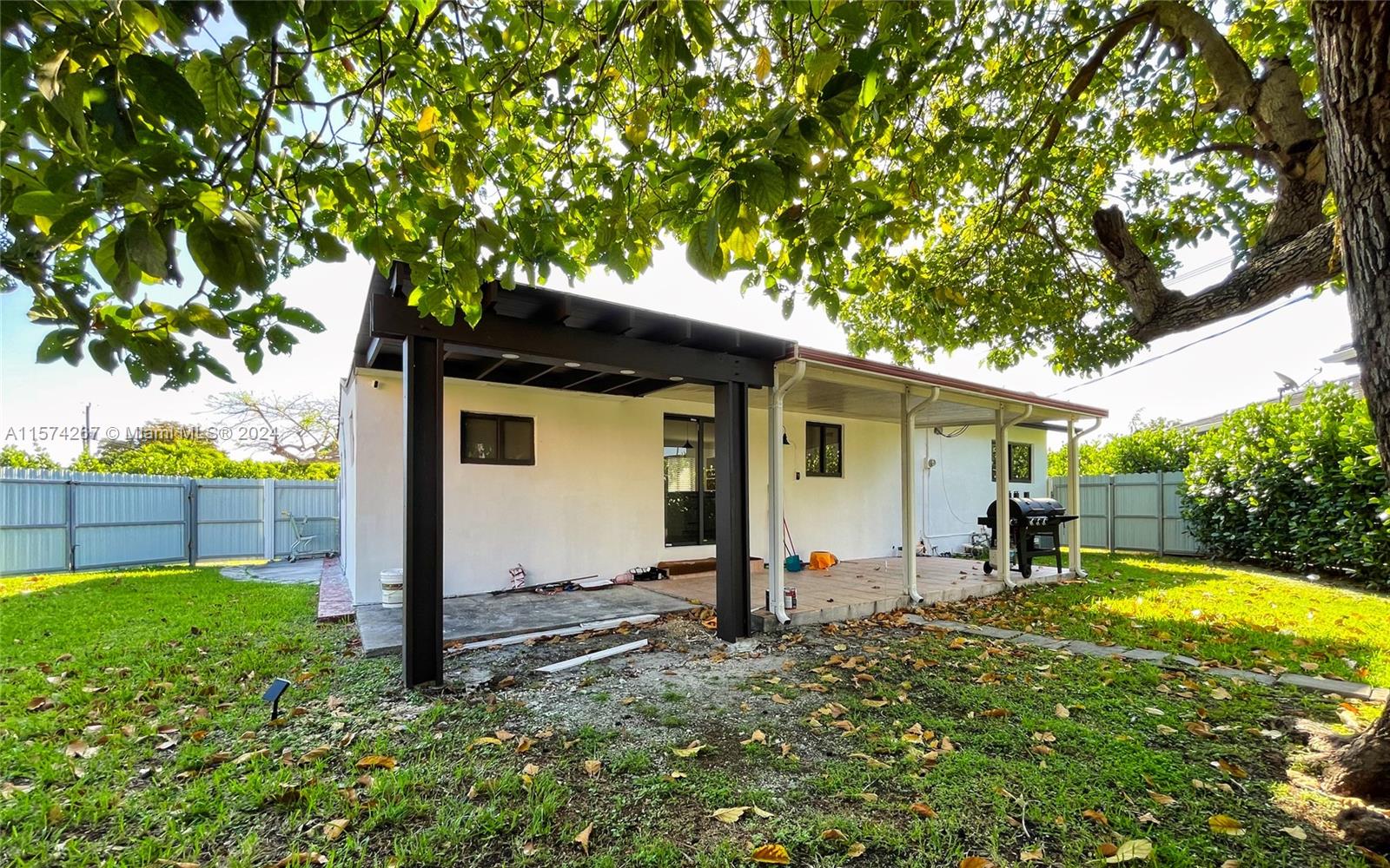 7040 Southwest 17th Terrace Miami, FL 33155 - Photo 25 of 26 a view of a house with a large tree and a yard