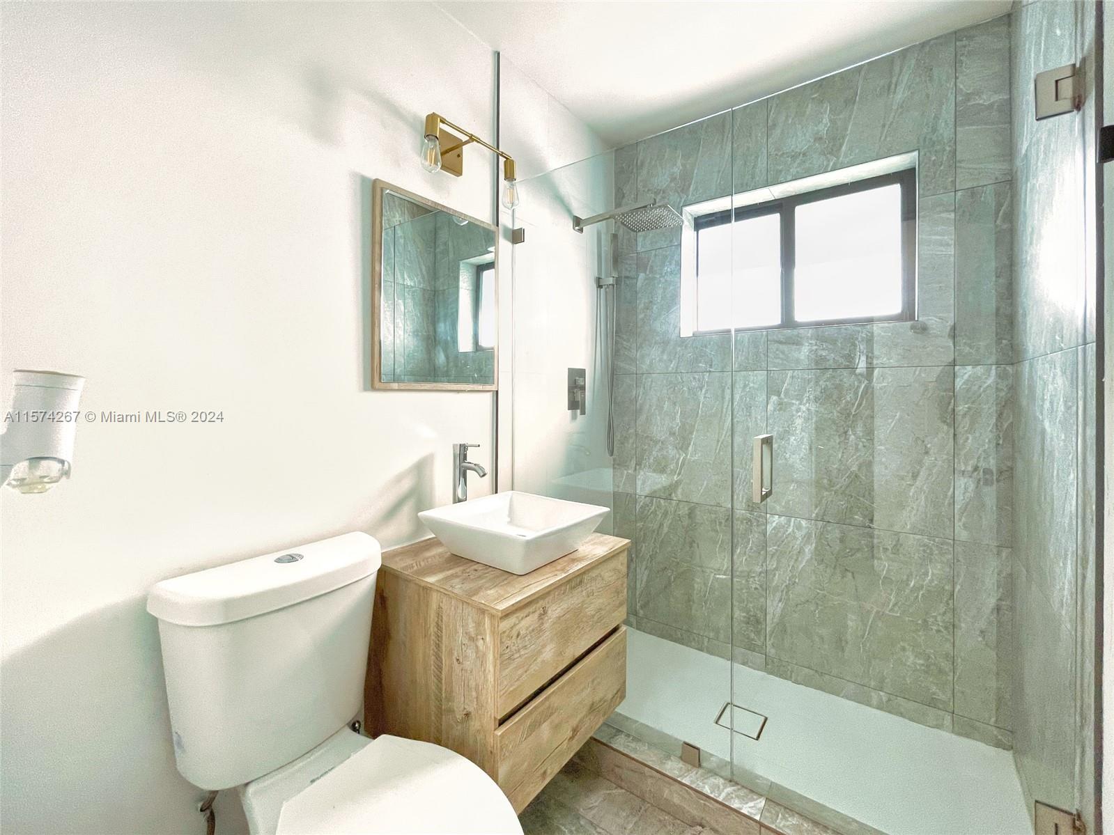 7040 Southwest 17th Terrace Miami, FL 33155 - Photo 3 of 26 a bathroom with a toilet a sink and shower