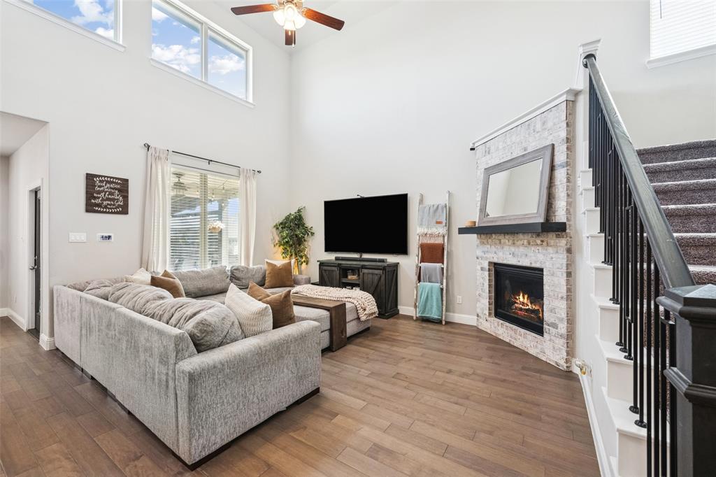 11852 Toppell Trail Fort Worth, TX 76052 - Photo 5 of 32 a living room with furniture a flat screen tv and a fireplace