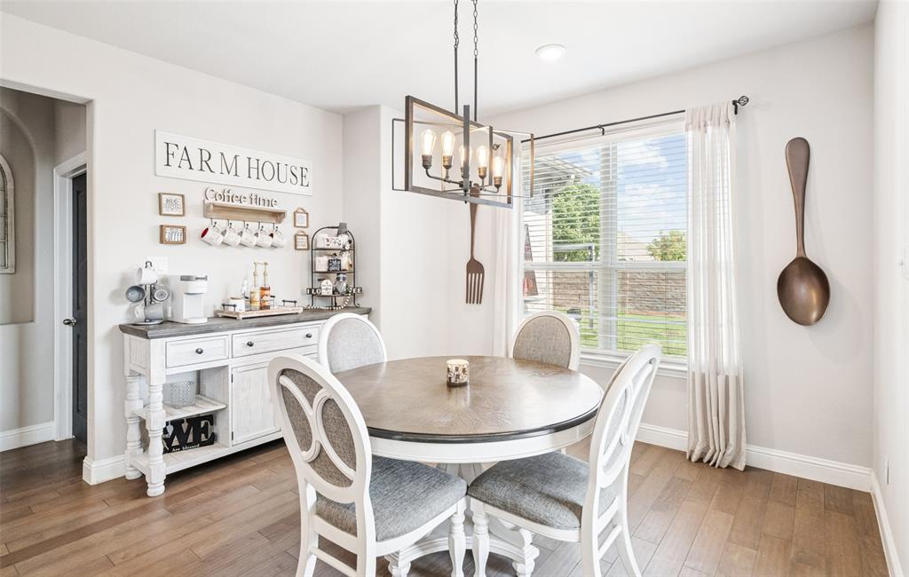 11852 Toppell Trail Fort Worth, TX 76052 - Photo 8 of 32 a dining room with furniture a chandelier and wooden floor
