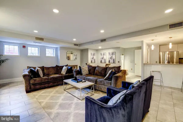 a living room with furniture and a chandelier
