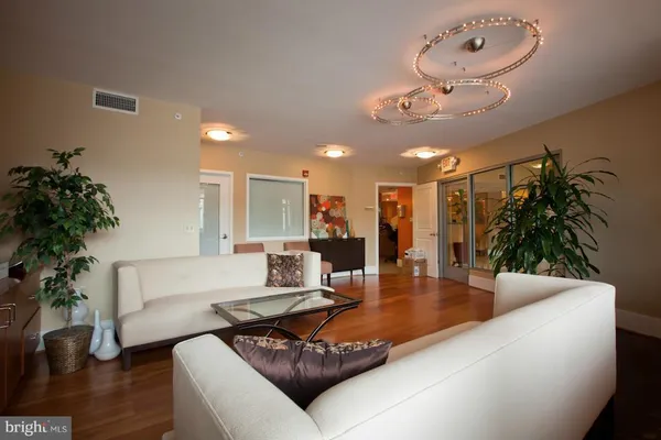 a kitchen with stainless steel appliances kitchen island granite countertop a refrigerator and a sink