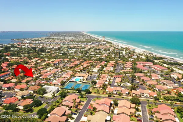 an aerial view of a house with swimming pool outdoor seating