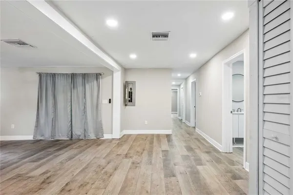 a view of hallway with wooden floor