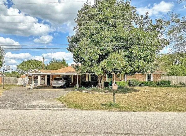 a view of a white house with a ocean view