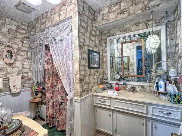 a sink and a mirror with shower in the house