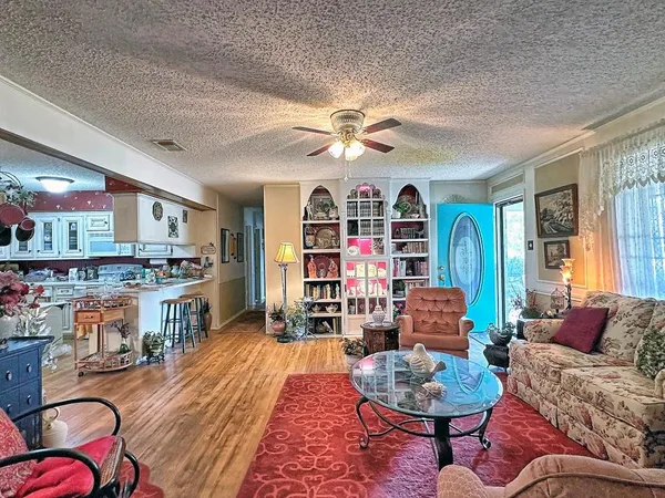 a living room with fireplace furniture and a rug