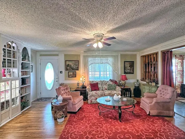 a living room with furniture a window and a bookshelf