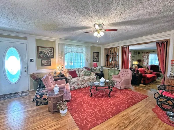 a living room with furniture or couch and a mirror