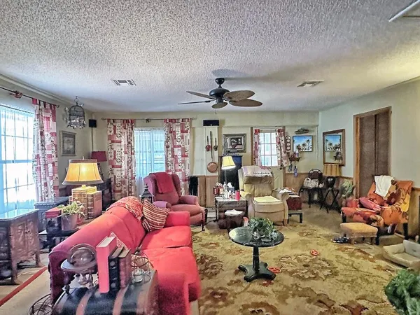 a living room with furniture a rug and a window