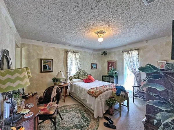 a bedroom with bed and a window