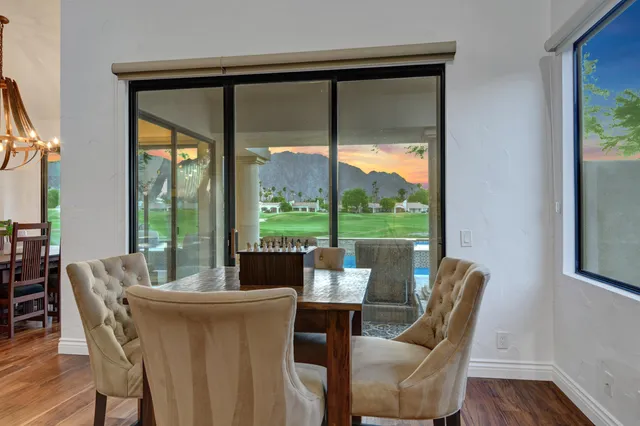 a dining room with furniture window and wooden floor